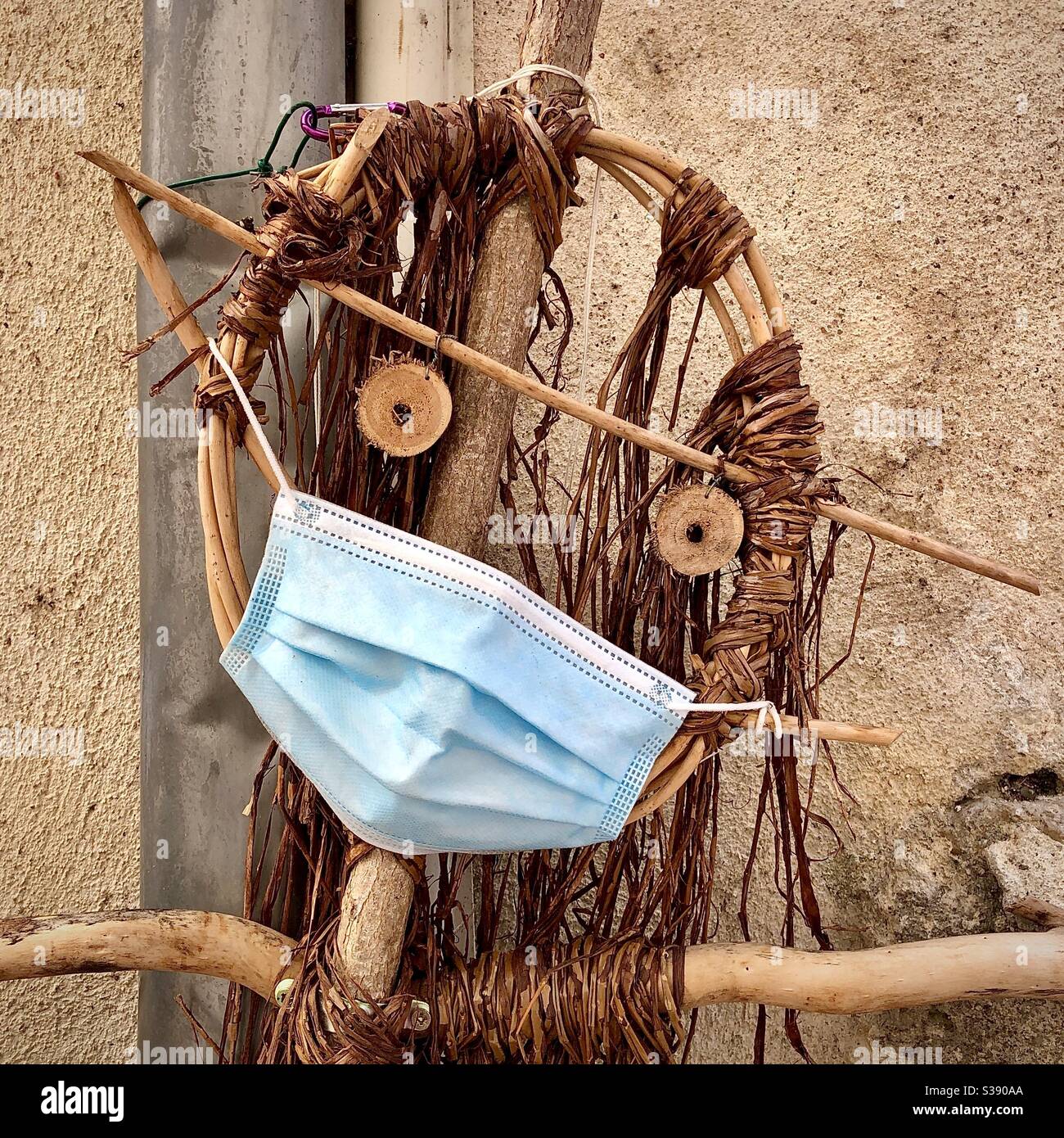 Hand-made marionette from sticks and twine, wearing Covid-19 face mask protection. - Smartphone Captured Stock Image