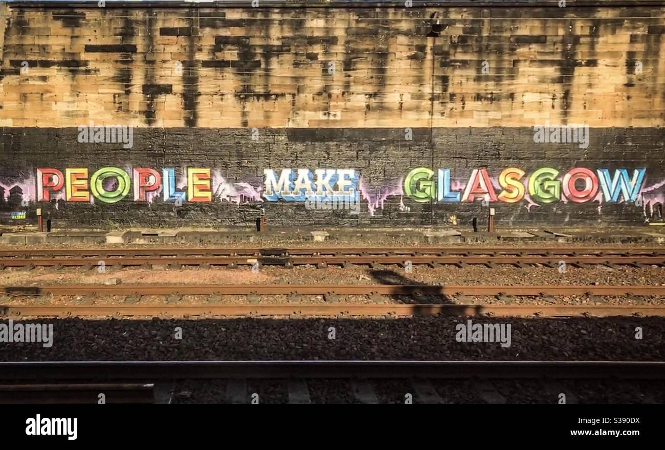 People Make Glasgow graffiti next to railway tracks in Glasgow Stock Photo