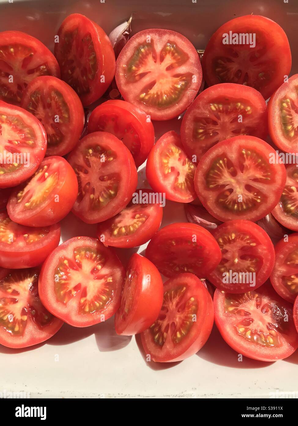 A pile of ripe tomatoes , cut in half Stock Photo