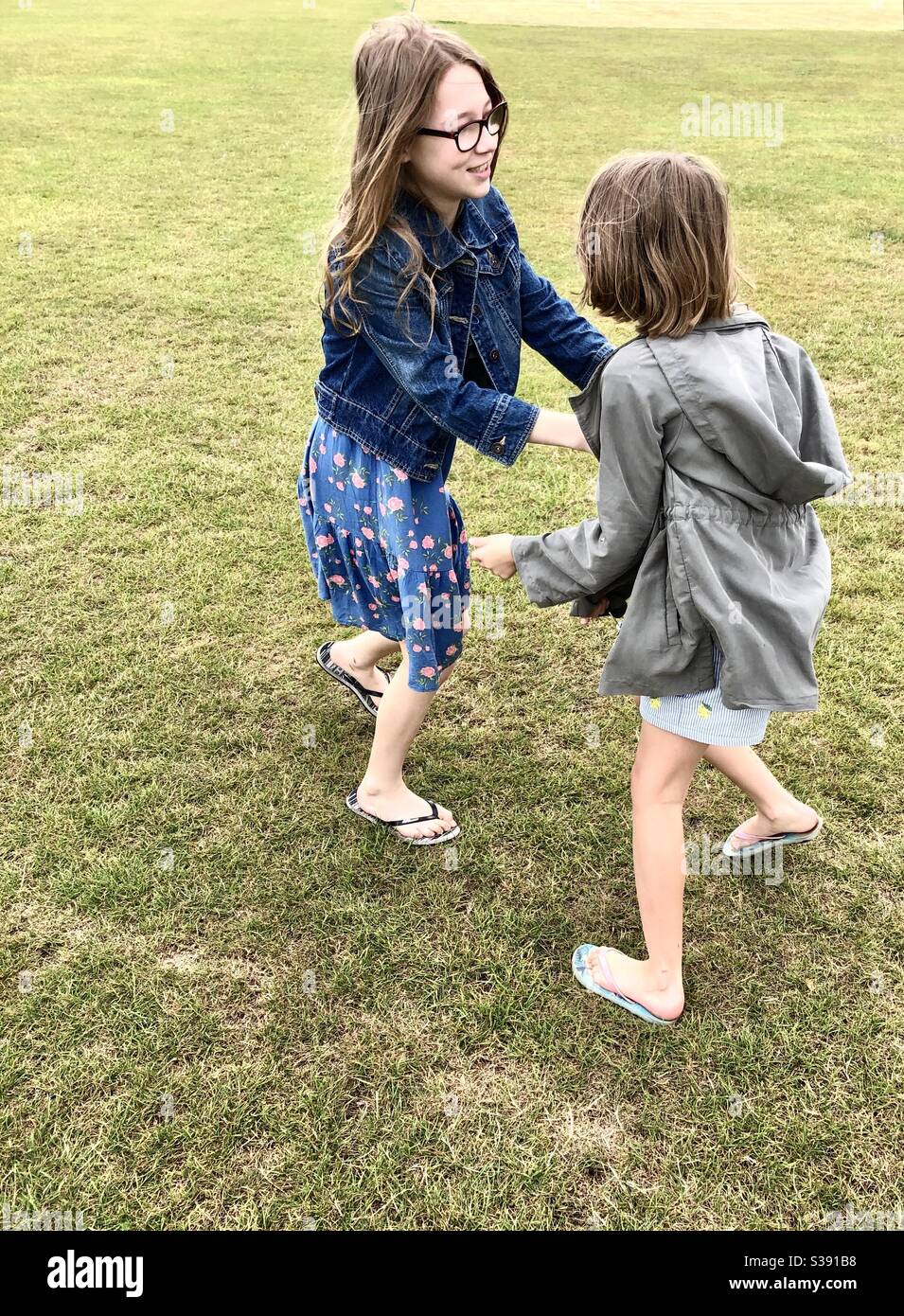 Two sisters play fighting - Smartphone Captured Stock Image