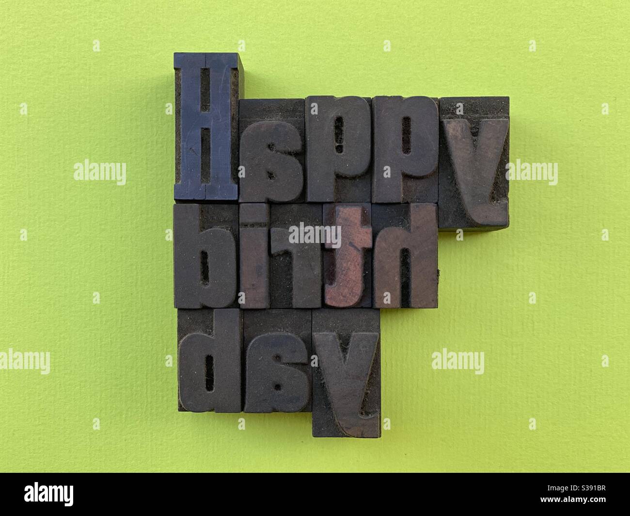 Happy Birthday composed with wooden letterpress with green background - Smartphone Captured Stock Image