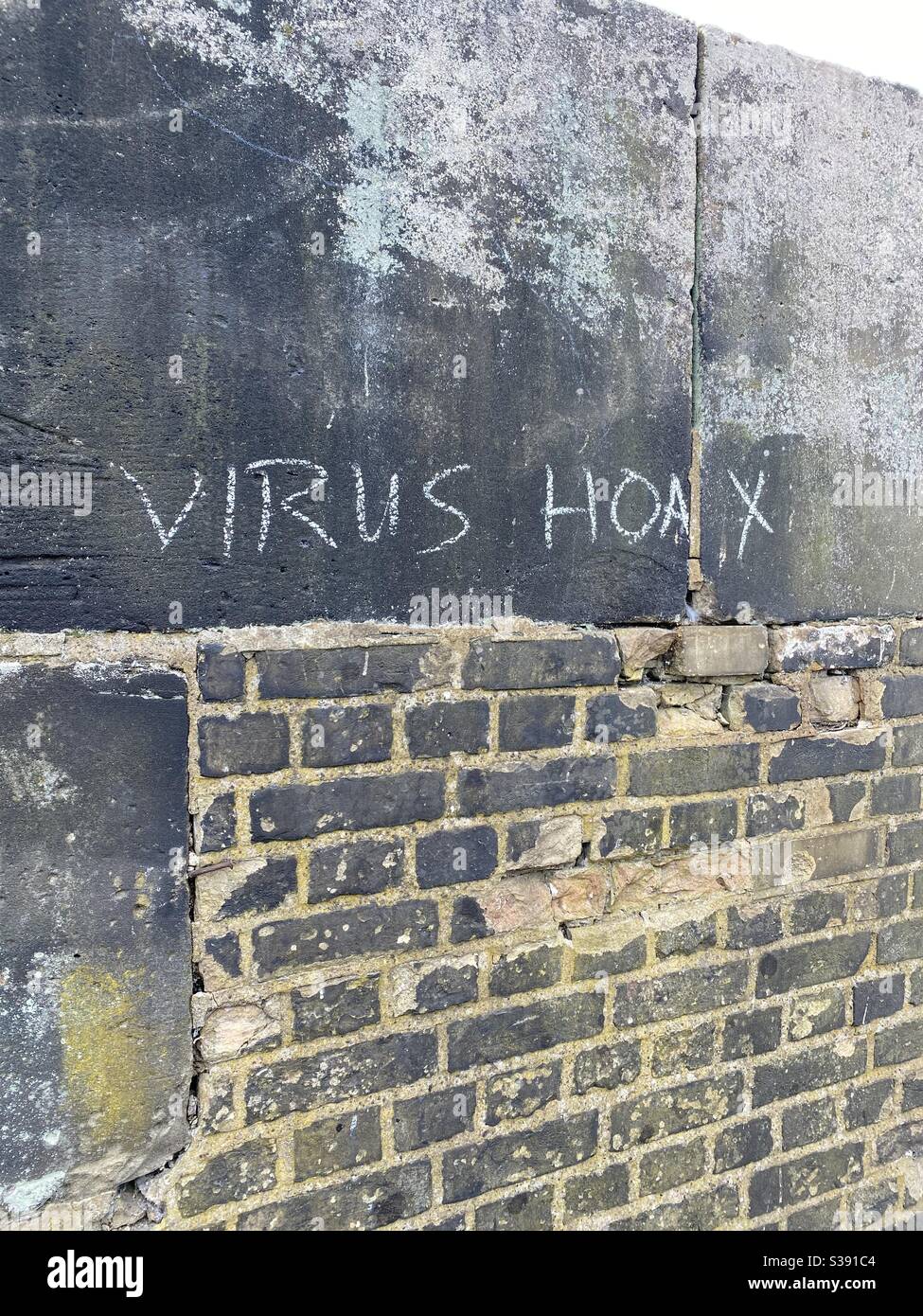 Graffiti in South London saying COVID-19 is fake Stock Photo