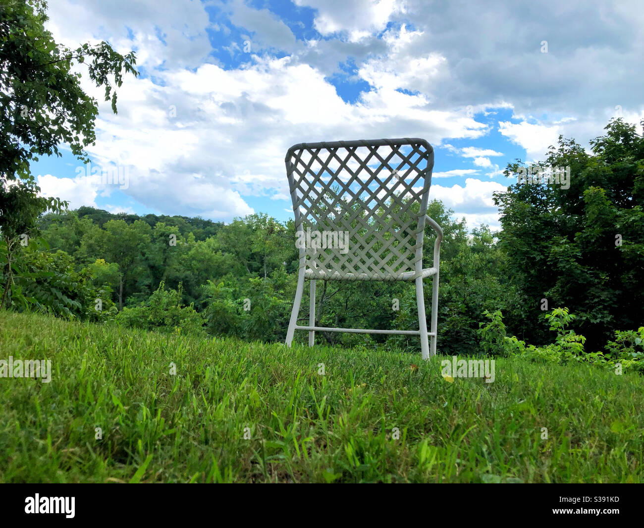 Single chair placed to enjoy views of large property, to be alone with your thoughts in nature - Smartphone Captured Stock Image