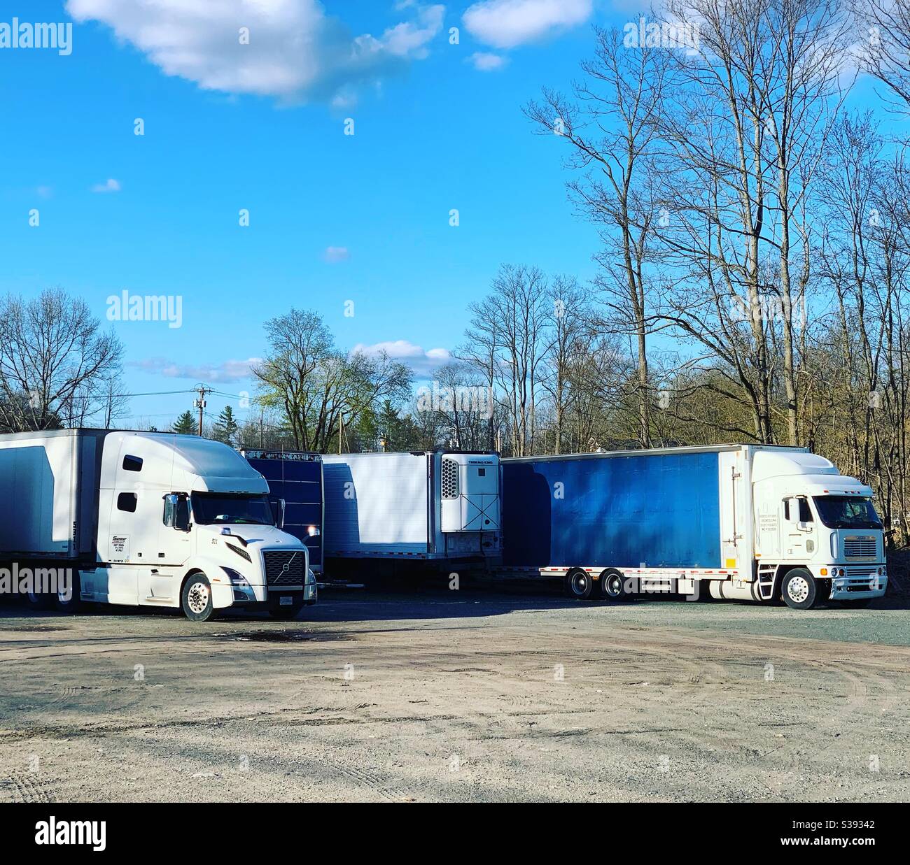 Commercial trucks parked under a blue sky Stock Photo