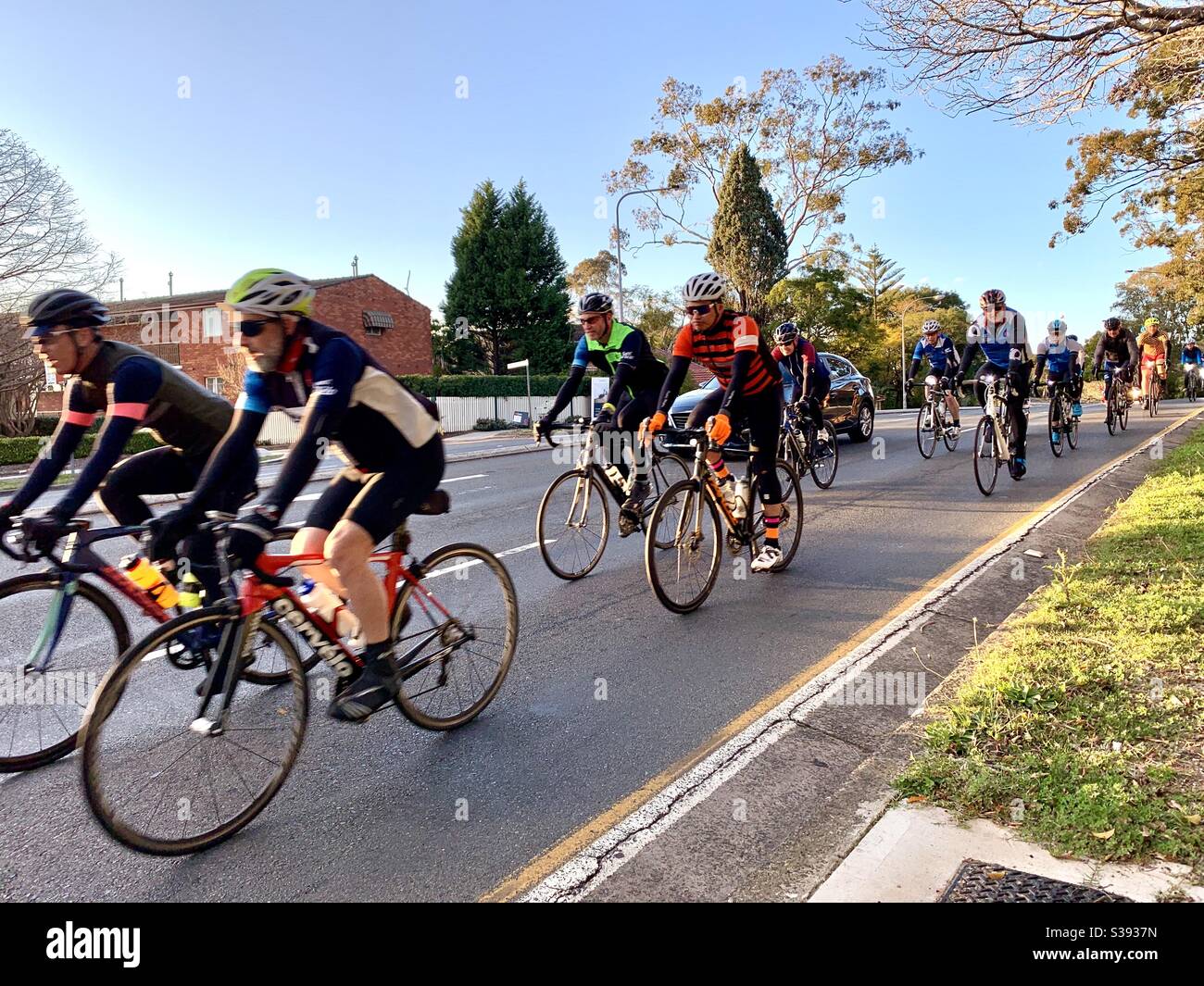 Sydney Australia August 22: Early morning bike riders brave the cold (9c) of a Sydney winter’s morning to ride north on the Pacific Highway through Gordon. - Smartphone Captured Stock Image