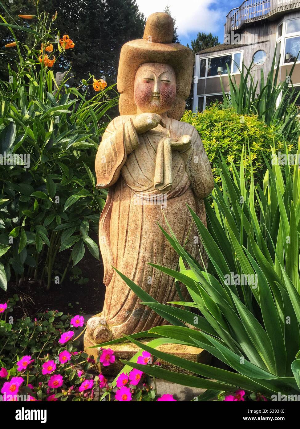 Asian inspired statue in the garden. - Smartphone Captured Stock Image