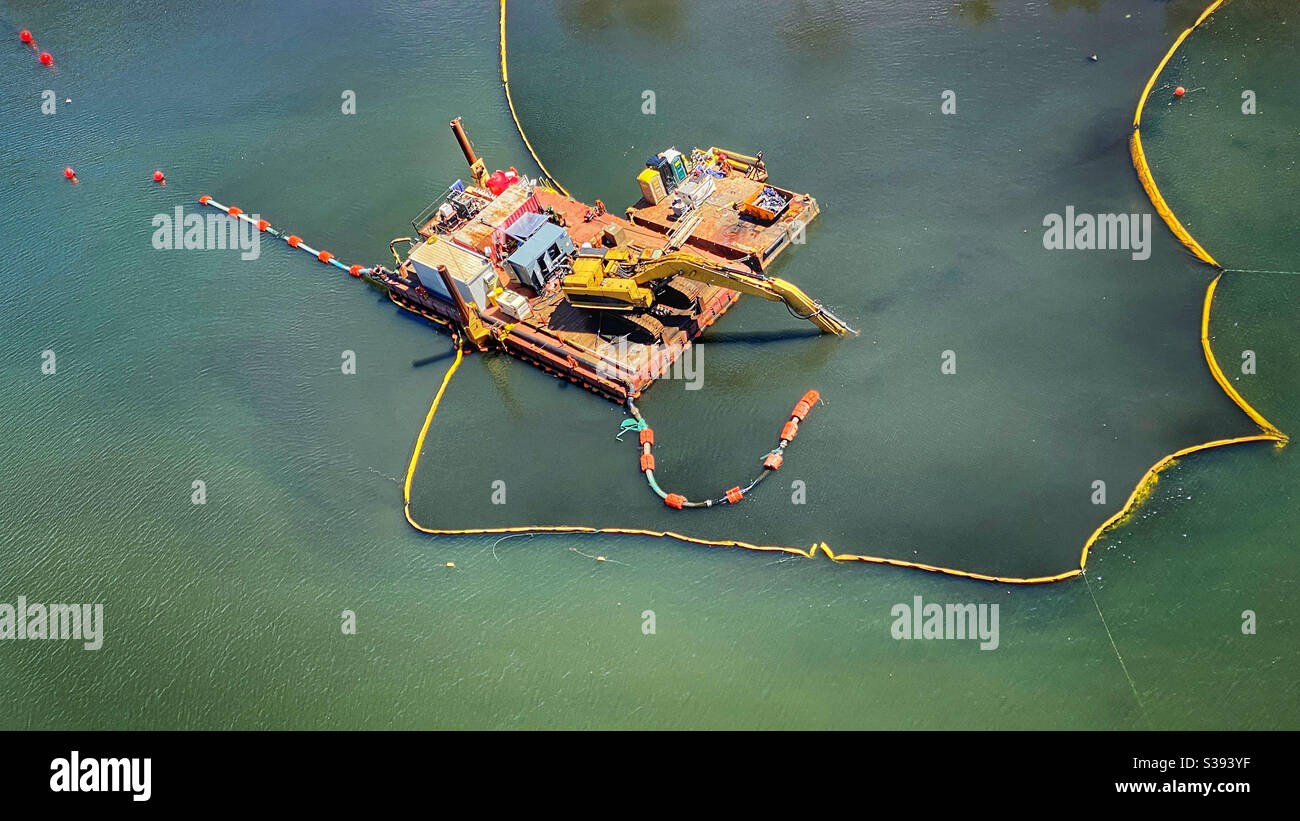 Dredging platform on a polluted canal Stock Photo