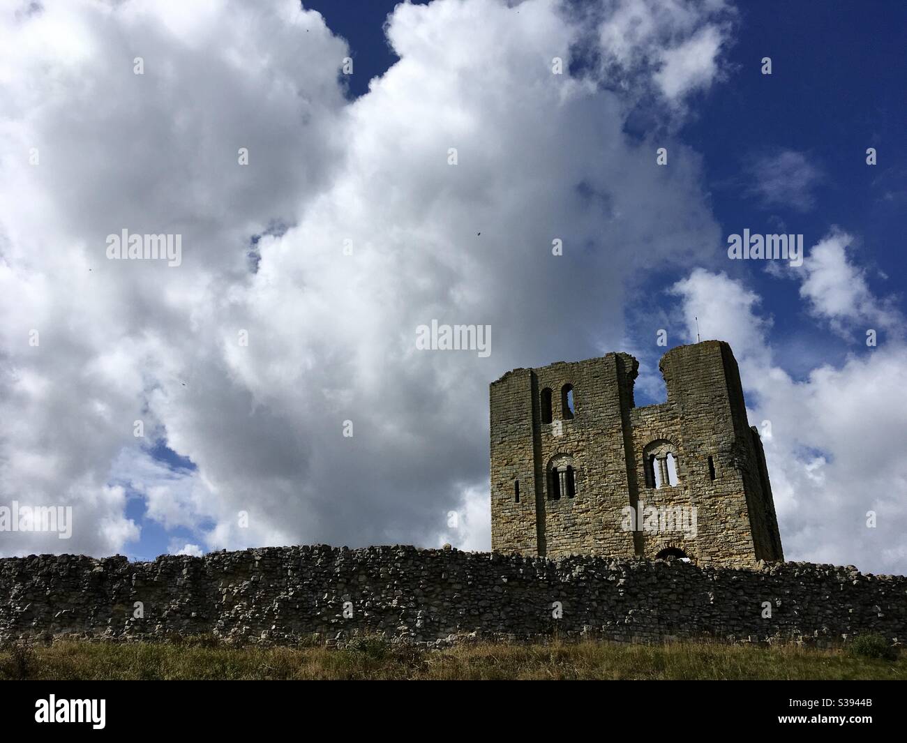 The Keep of Scarborough Castle, built by the Plantagenet King Henry II, in the twelfth century, standing against a dramatic sky. - Smartphone Captured Stock Image