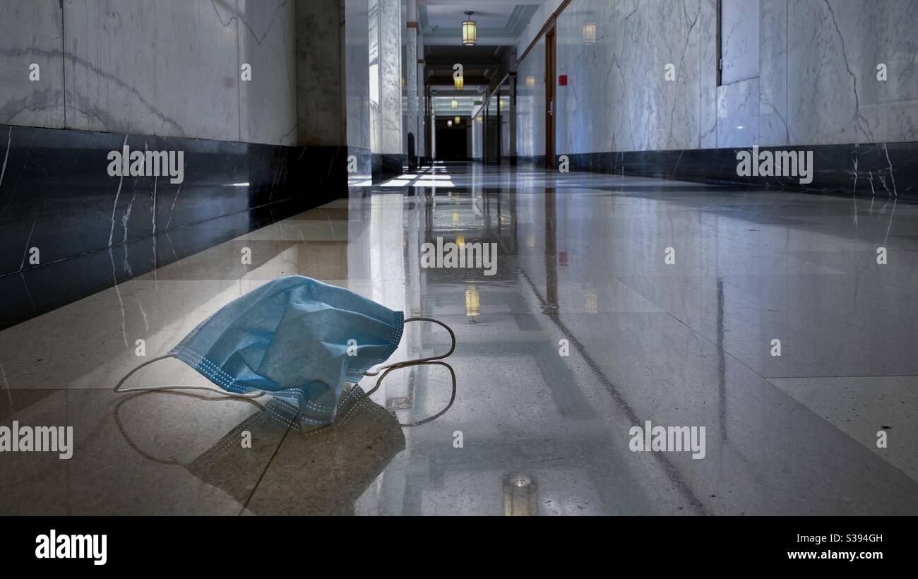 LOS ANGELES, CA, JUL 2020: dropped medical mask on floor in corridor during coronavirus Covid-19 pandemic - Smartphone Captured Stock Image