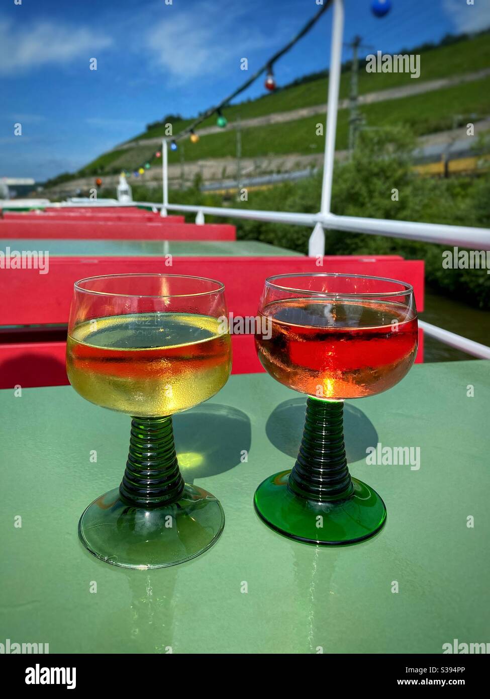 Drinking local wine from Würzburg region on a boat trip on river Main with wineries view. - Smartphone Captured Stock Image