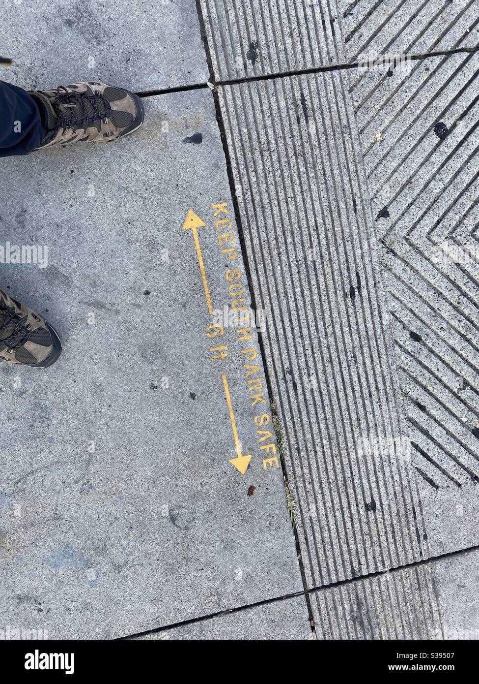 LOS ANGELES, CA, JUL 2020: warning on sidewalk indicates six-feet social distancing rules during coronavirus pandemic in Downtown - Smartphone Captured Stock Image