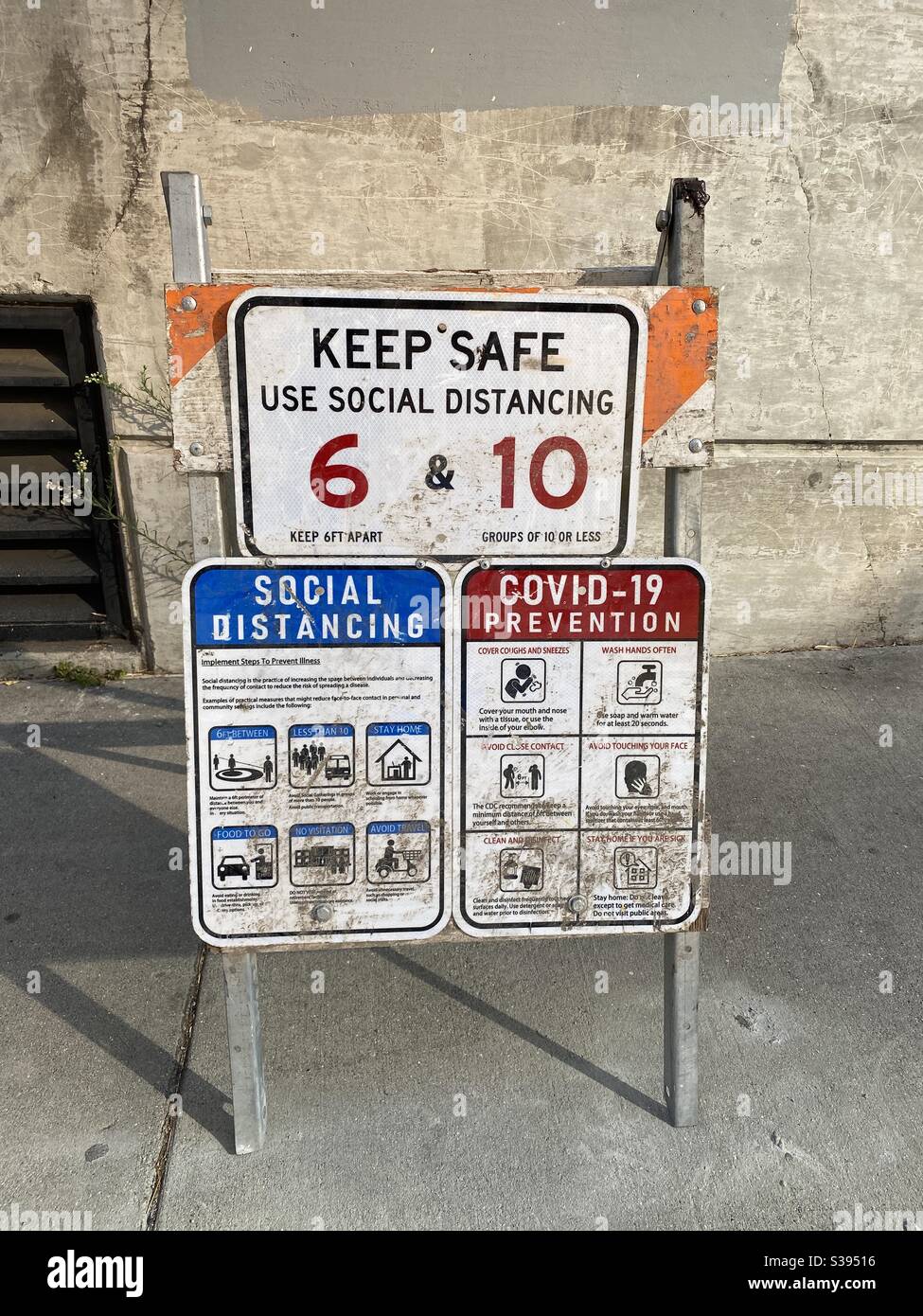 LOS ANGELES, CA, AUG 2020: social distancing and Covid-19 presentation sign at side of street in Downtown during coronavirus pandemic - Smartphone Captured Stock Image