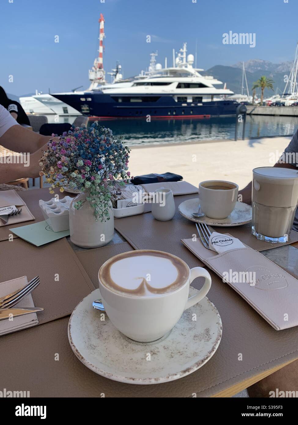 Morning coffee in Porto Montenegro with super yacht - Smartphone Captured Stock Image