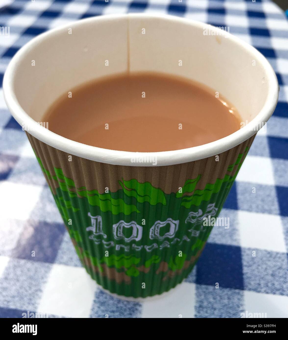 Cup of Tea in compostable paper cup on chequered table cloth - Smartphone Captured Stock Image