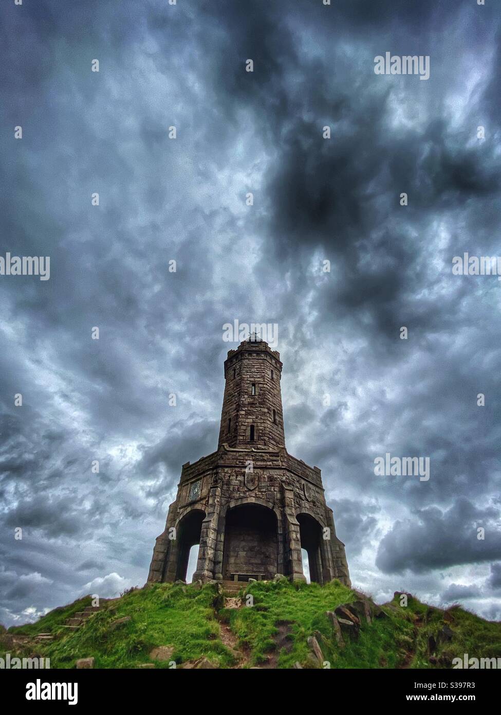 Jubilee Tower (the Rocket) on Darwen Moor from low angle against a dramatic sky above Blackburn in Lancashire - Smartphone Captured Stock Image