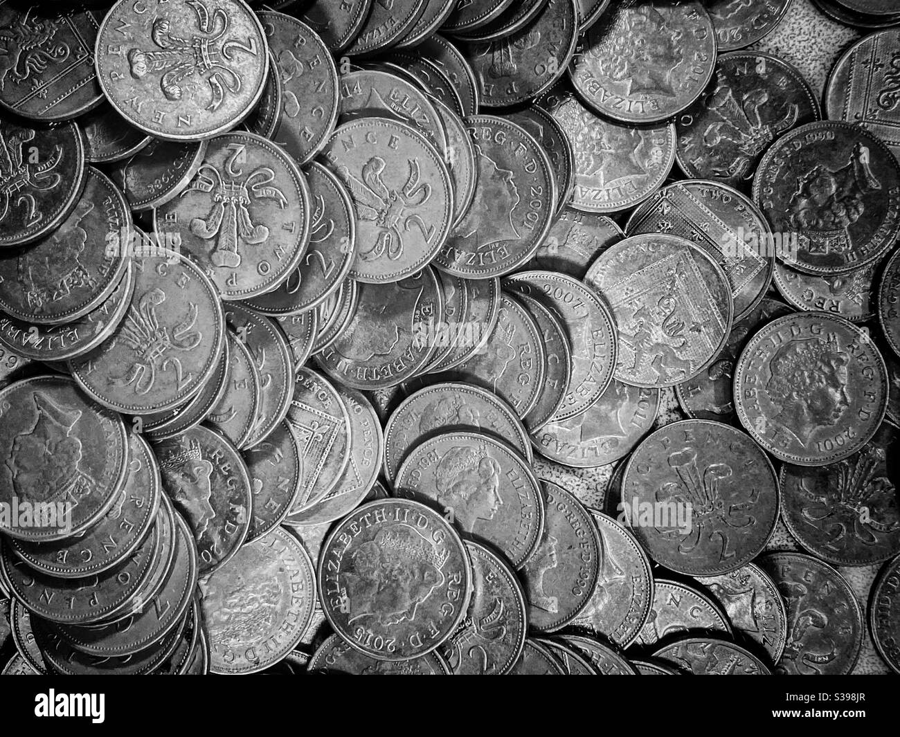 A large group of British Two Pence pieces. Slightly different designs depicting various images of Queen Elizabeth II. Photo Credit - ©️ COLIN HOSKINS. - Smartphone Captured Stock Image