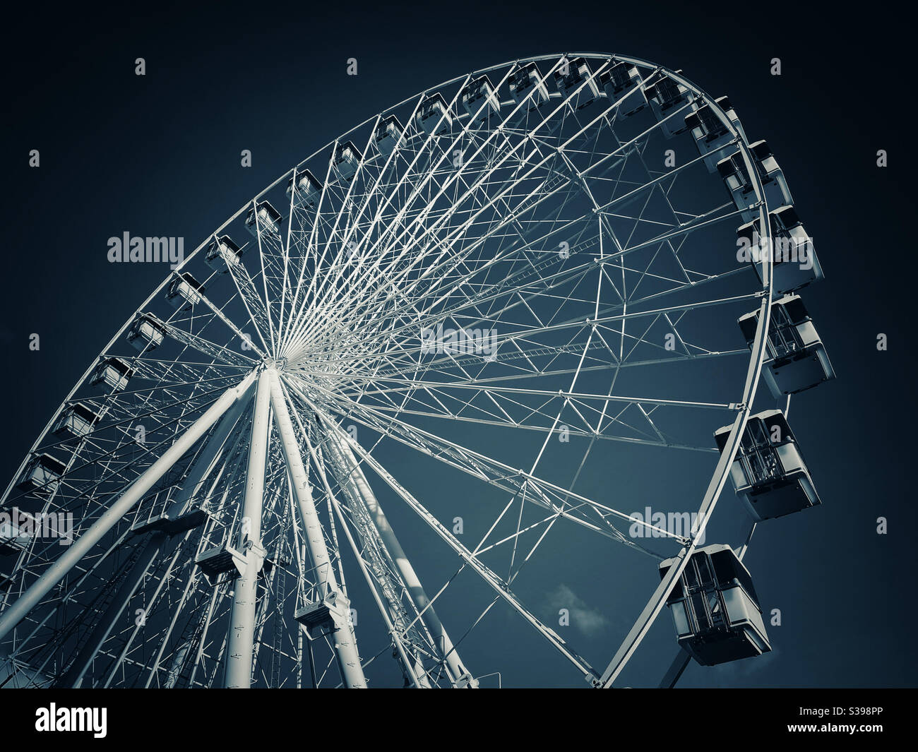 Looking up at a large Ferris Wheel. It’s great fun looking down at the earth from high up! Photo Credit ©️ COLIN HOSKINS. - Smartphone Captured Stock Image