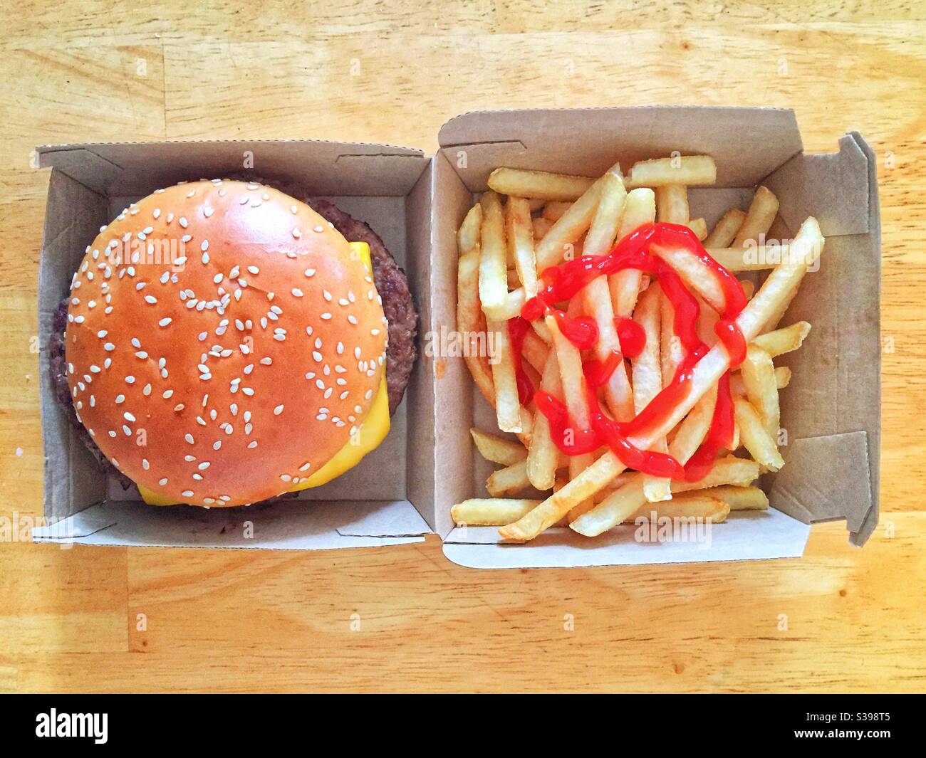 Cheeseburger with fries and lots of ketchup. - Smartphone Captured Stock Image