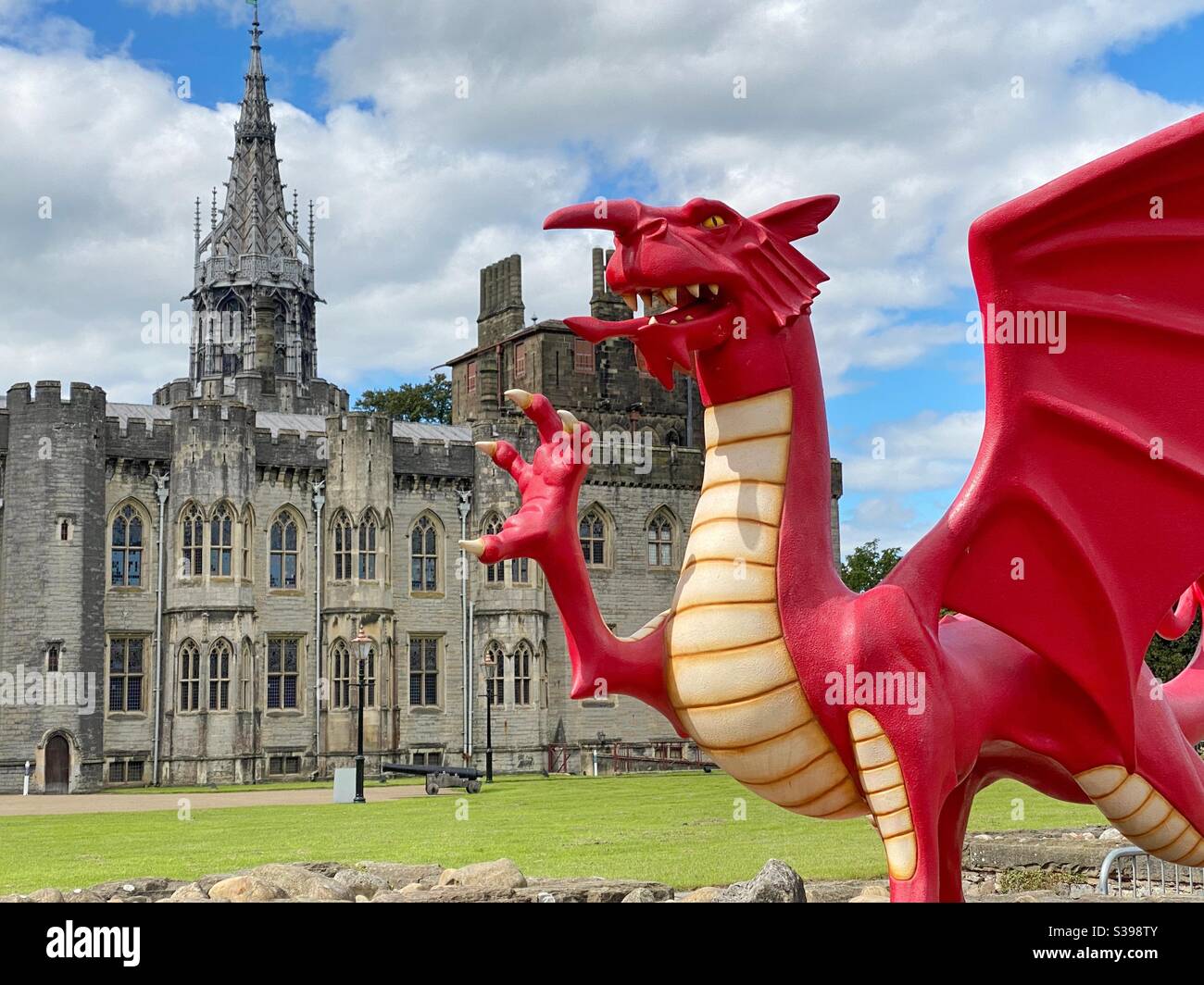 Model of red dragon in front of one of the buildings in the ground of Cardiff Castle Stock Photo