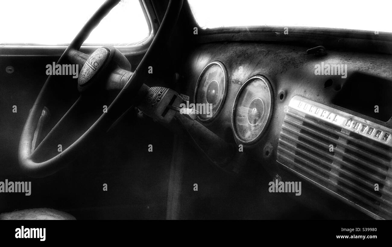 Black and white image of an old rusty GMC truck dashboard Stock Photo