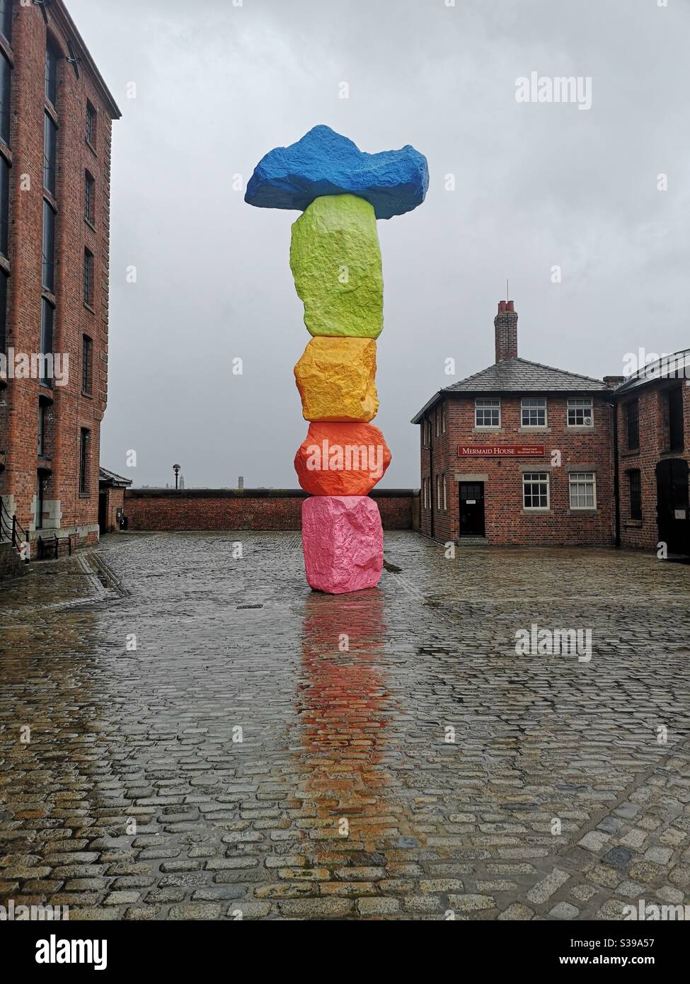 Ugo Rondinone sculpture outside Tate Liverpool representing stack of coloured stones Stock Photo