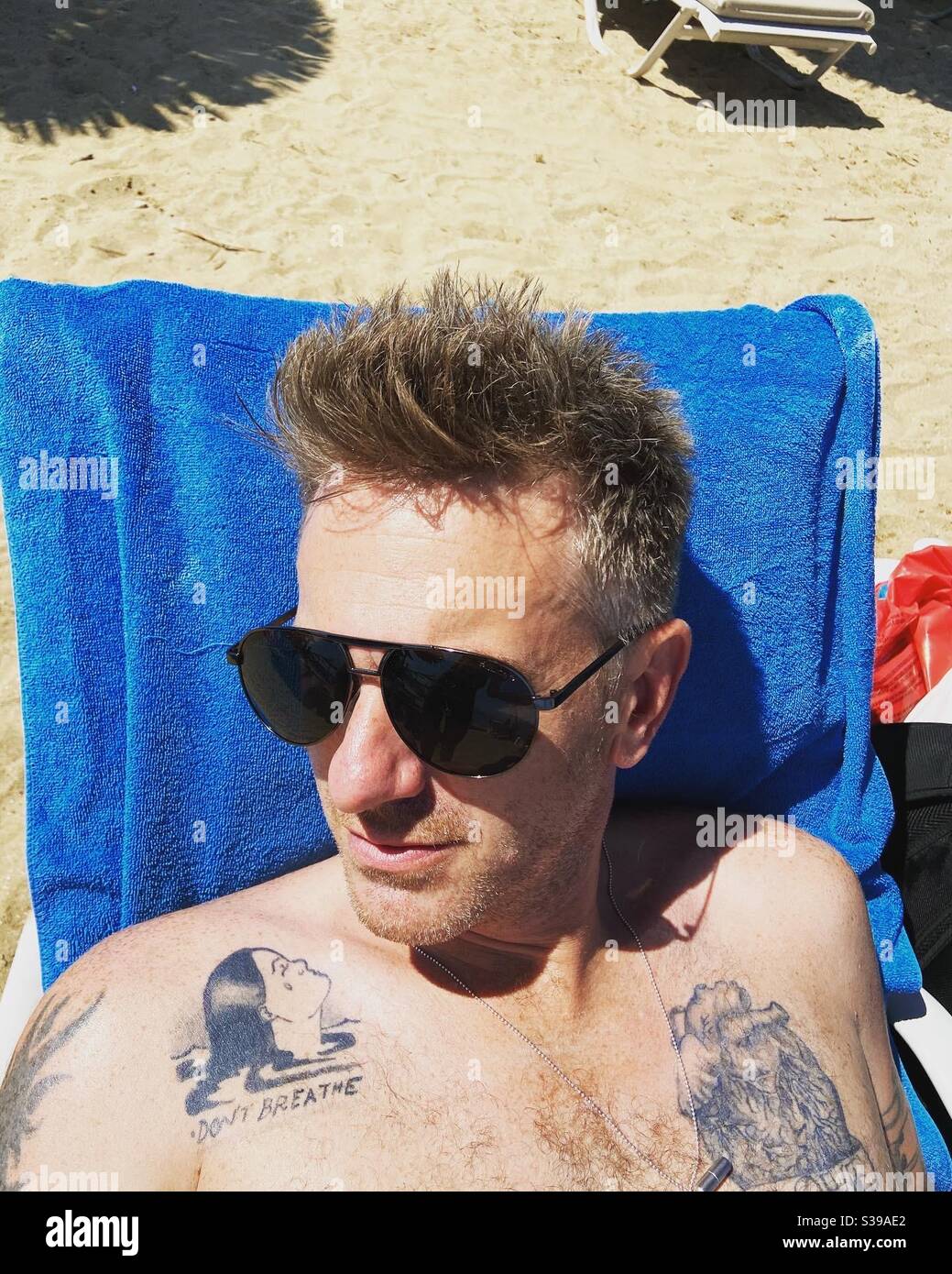 Man in sunglasses with tattoos - Smartphone Captured Stock Image