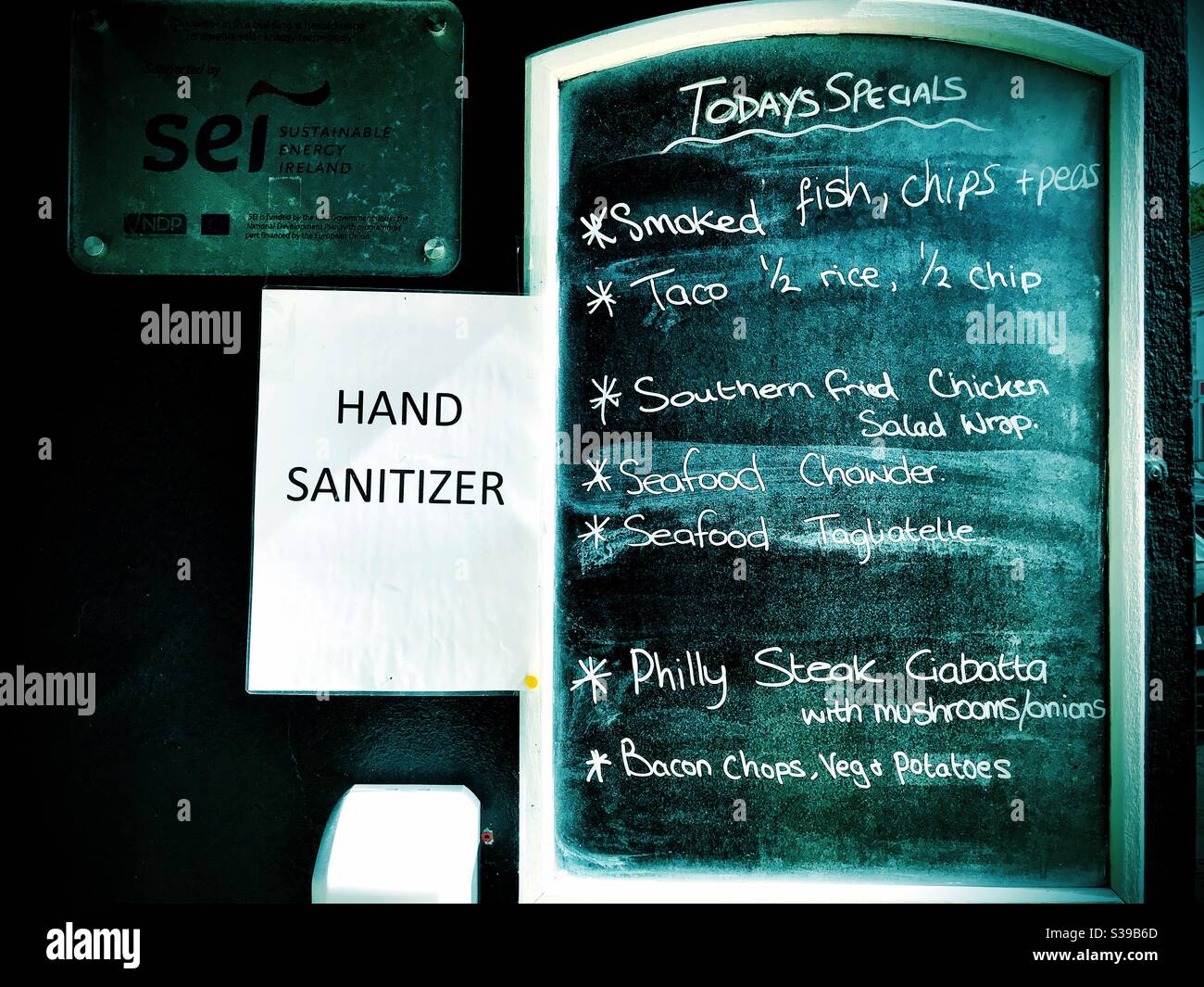 Cafe menu shows Today’s Specials with hand sanitizer dispenser during Covid19 pandemic. County Donegal Ireland - Smartphone Captured Stock Image