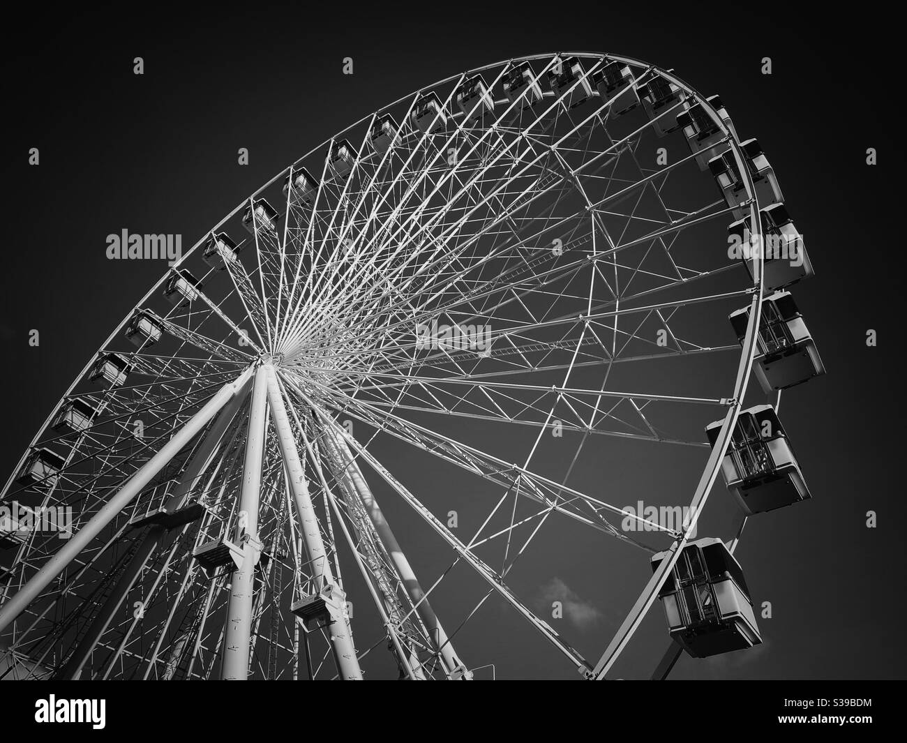 A dramatic image of a massive Ferris Wheel. View looking up into a dark sky. Photo Credit - ©️ COLIN HOSKINS. - Smartphone Captured Stock Image