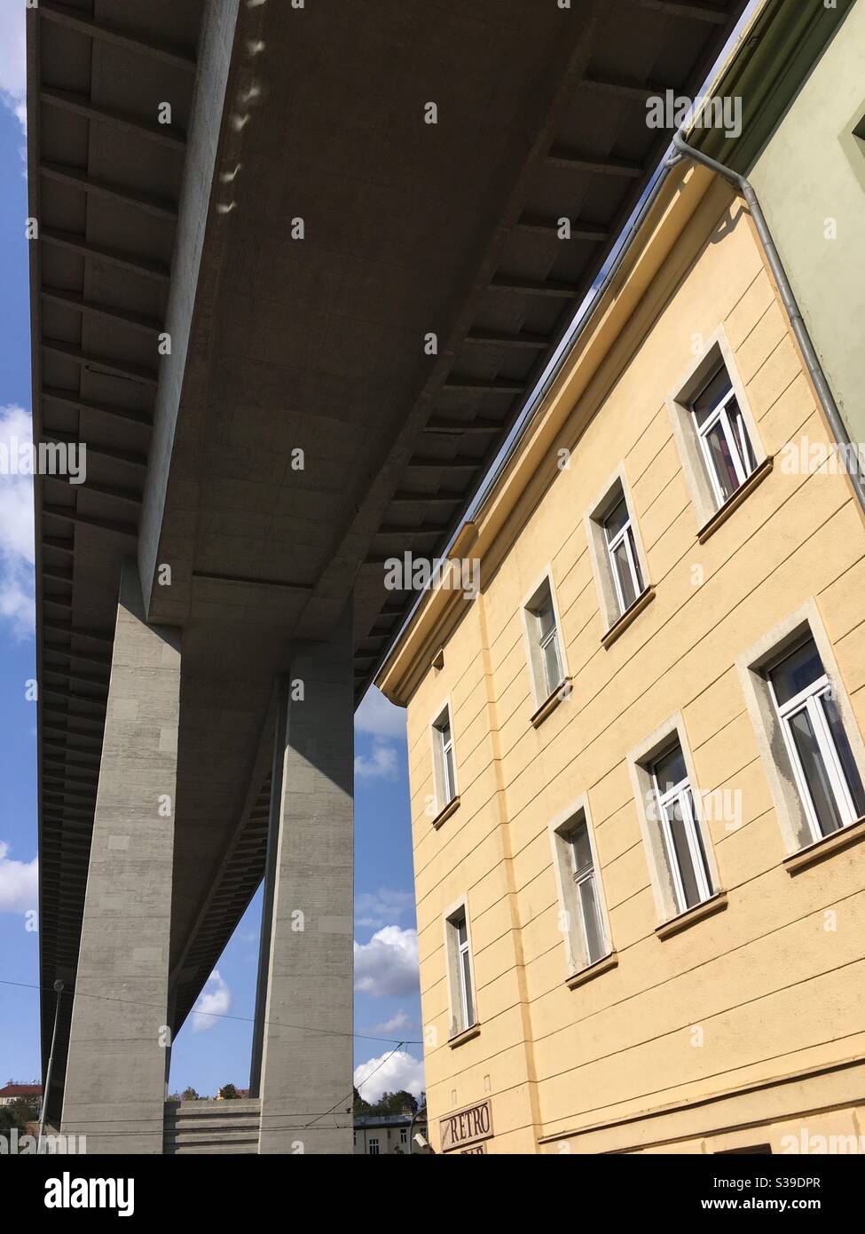 View from underneath the Nusle Bridge in Prague, infamous for being a popular suicide jumpers location, the picture is suggesting dark sky, since sky view is blocked by the shaded side of the bridge Stock Photo