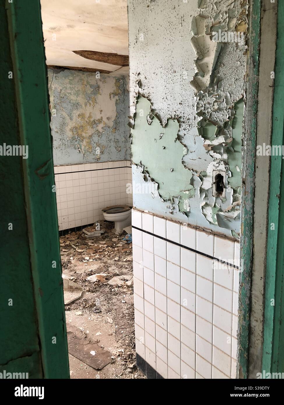 Chipping paint in abandoned bathroom Stock Photo
