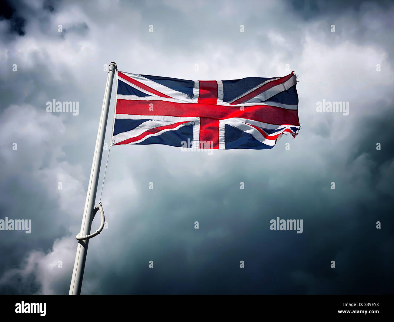 The flag of the United Kingdom flutters proudly in a strong wind. The red cross of St. George. The blue and white of the Scottish Nation. Photo - ©️ COLIN HOSKINS. - Smartphone Captured Stock Image