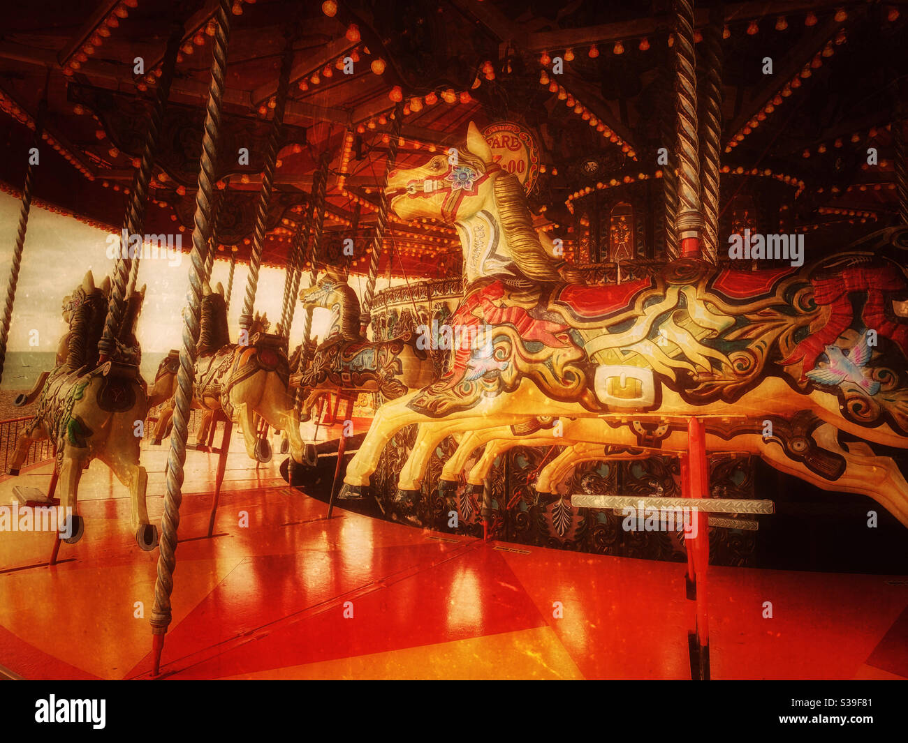Horses on a seaside carousel await happy riders. A moody, atmospheric and inviting image that evokes happy memories of childhood. Photo Credit - ©️ COLIN HOSKINS. - Smartphone Captured Stock Image