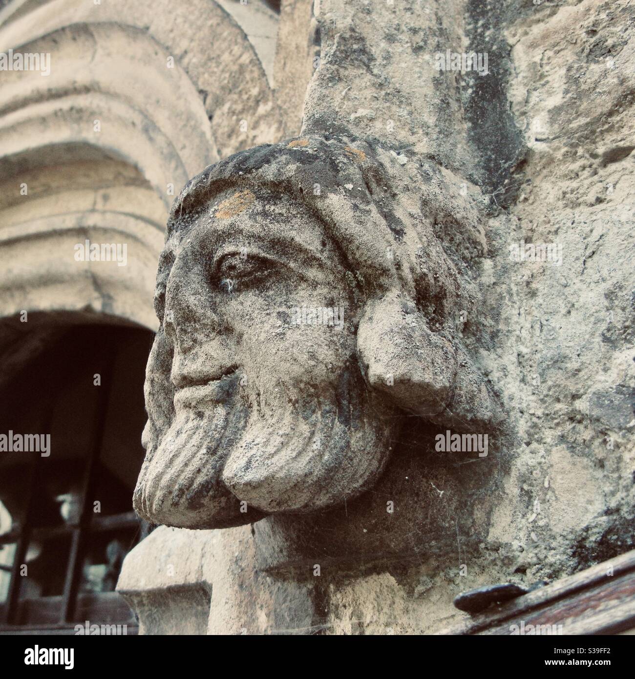 Stone face carved into St Neots Parish Church, St Neots, Cambridgeshire, England, UK. - Smartphone Captured Stock Image
