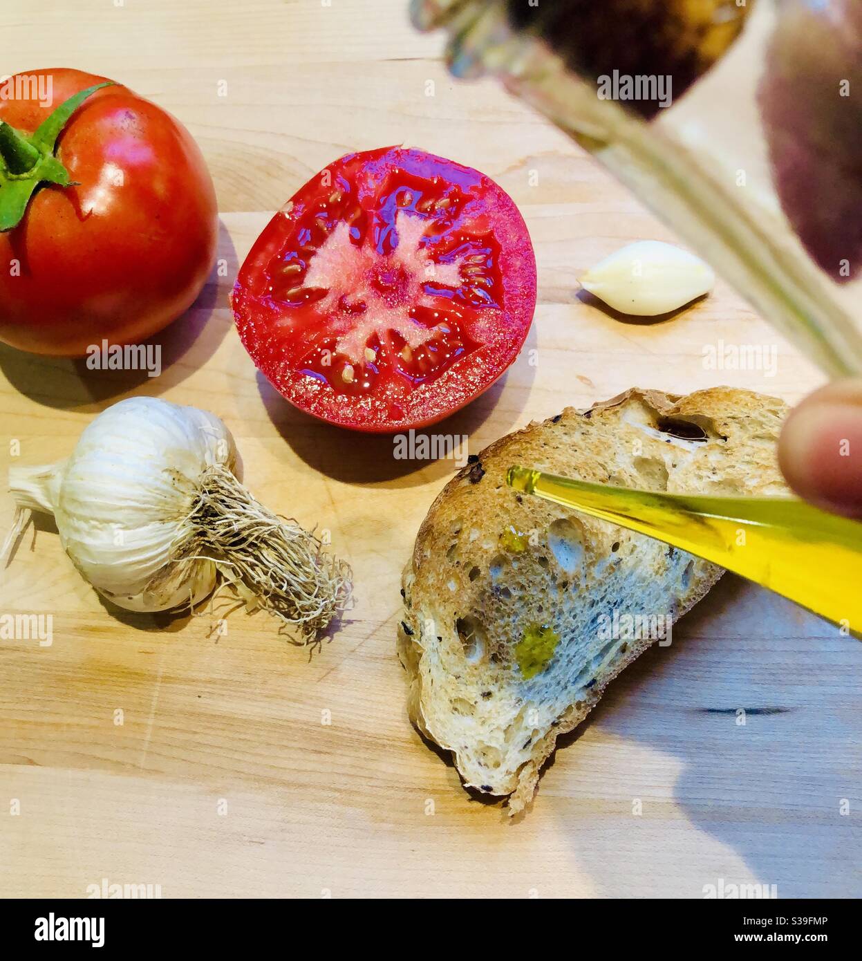 Preparation of bread tomaca a spanish traditional receipe - Smartphone Captured Stock Image