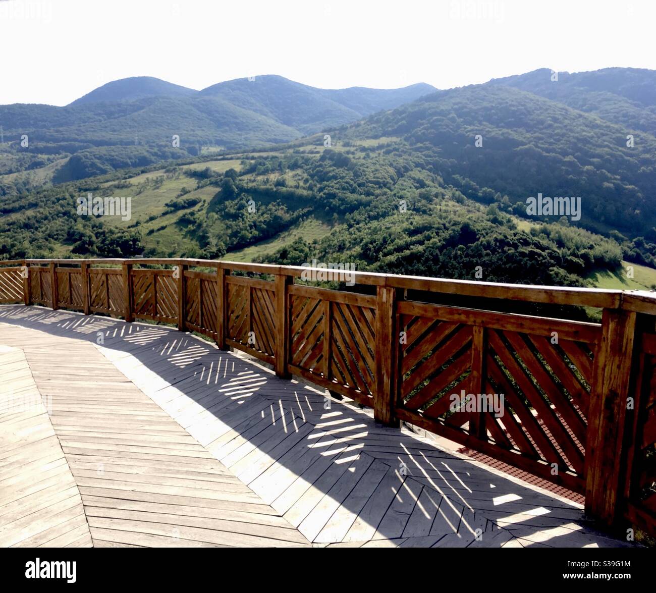 Wooden suspended platform near Deva Romania, with the Carpathian Mountains in the background Stock Photo