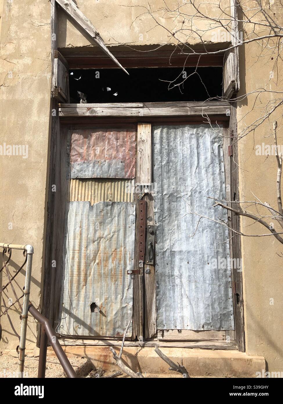 Boarded and locked up door to abandoned building Stock Photo