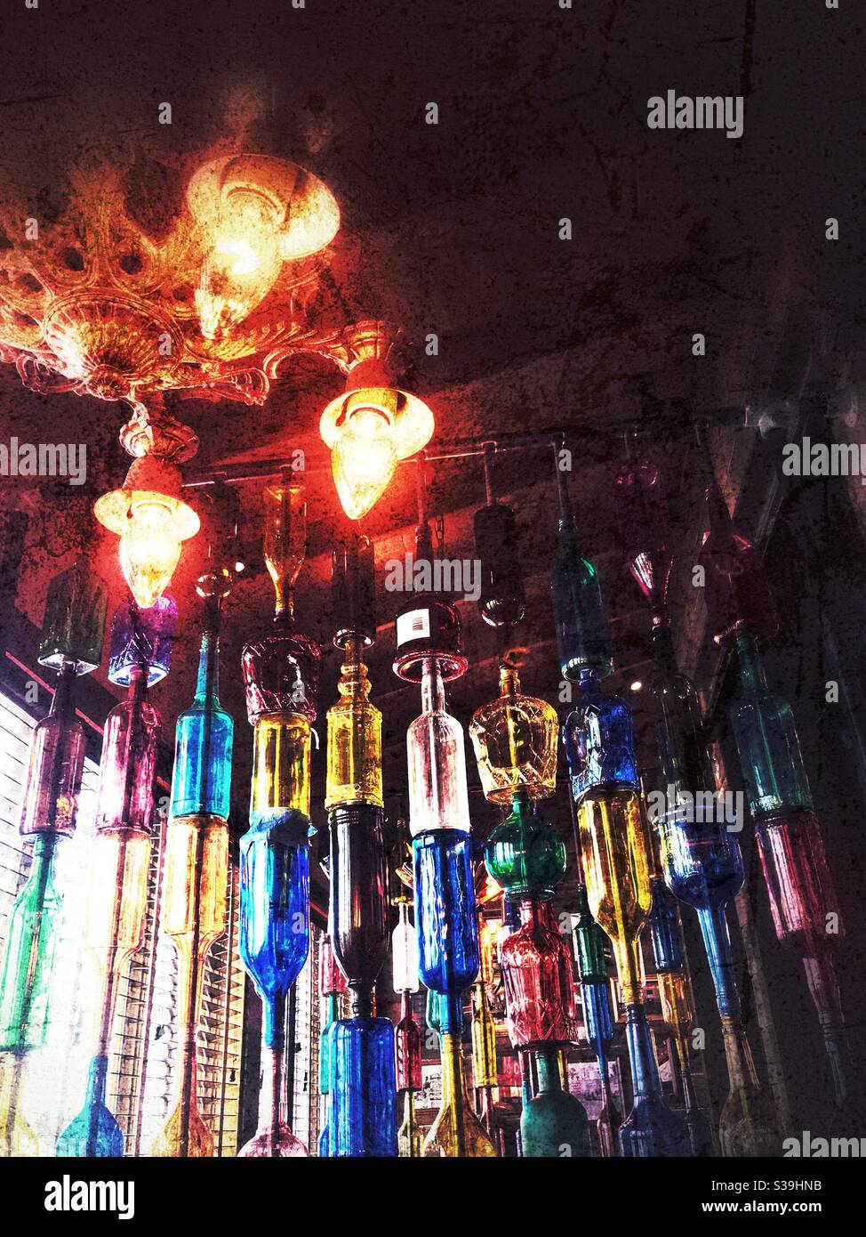 Gothic lamp and colored bottles lend ambiance at Cajun restaurant - Smartphone Captured Stock Image