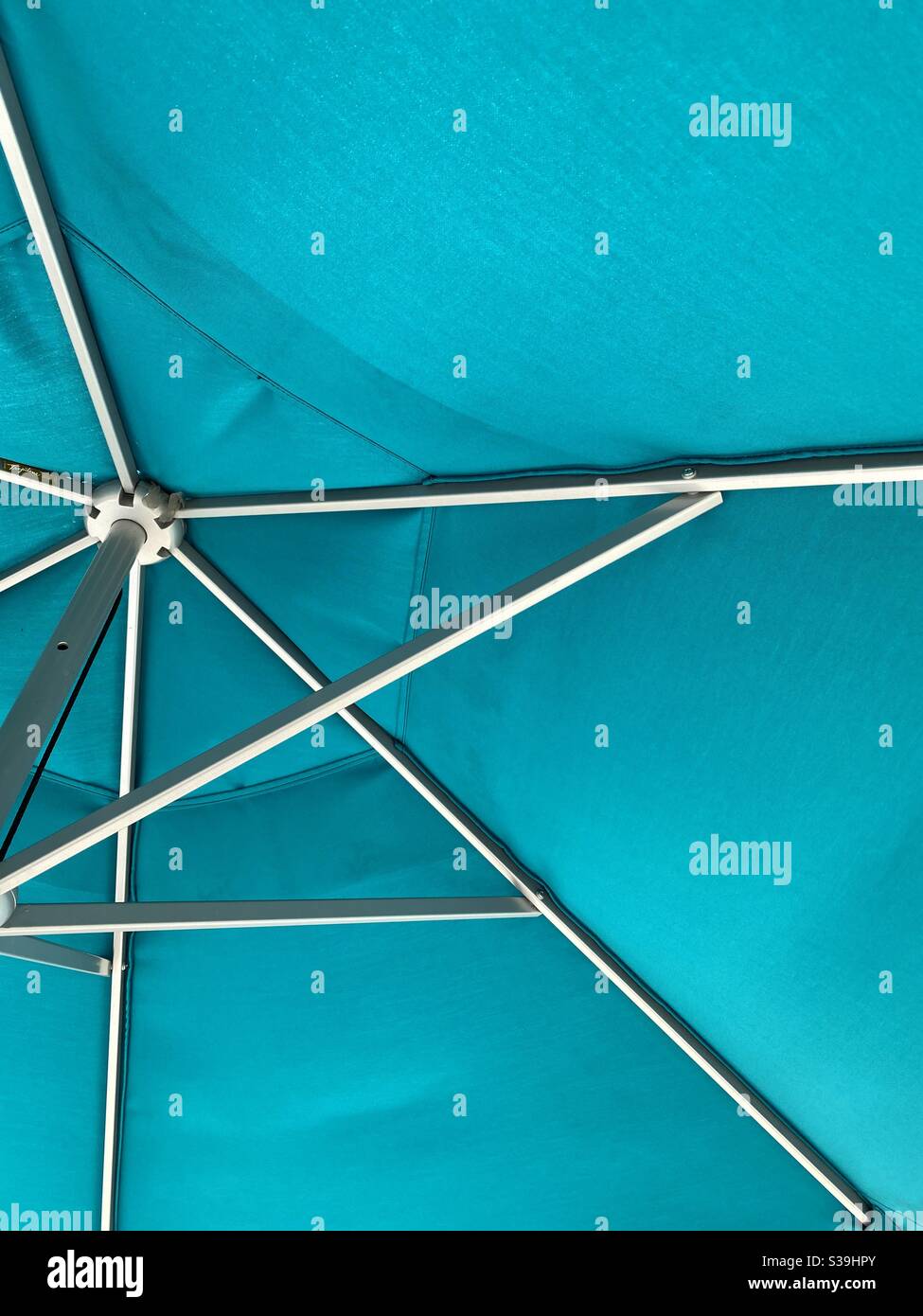 Underside of turquoise blue outdoor umbrella Stock Photo Alamy