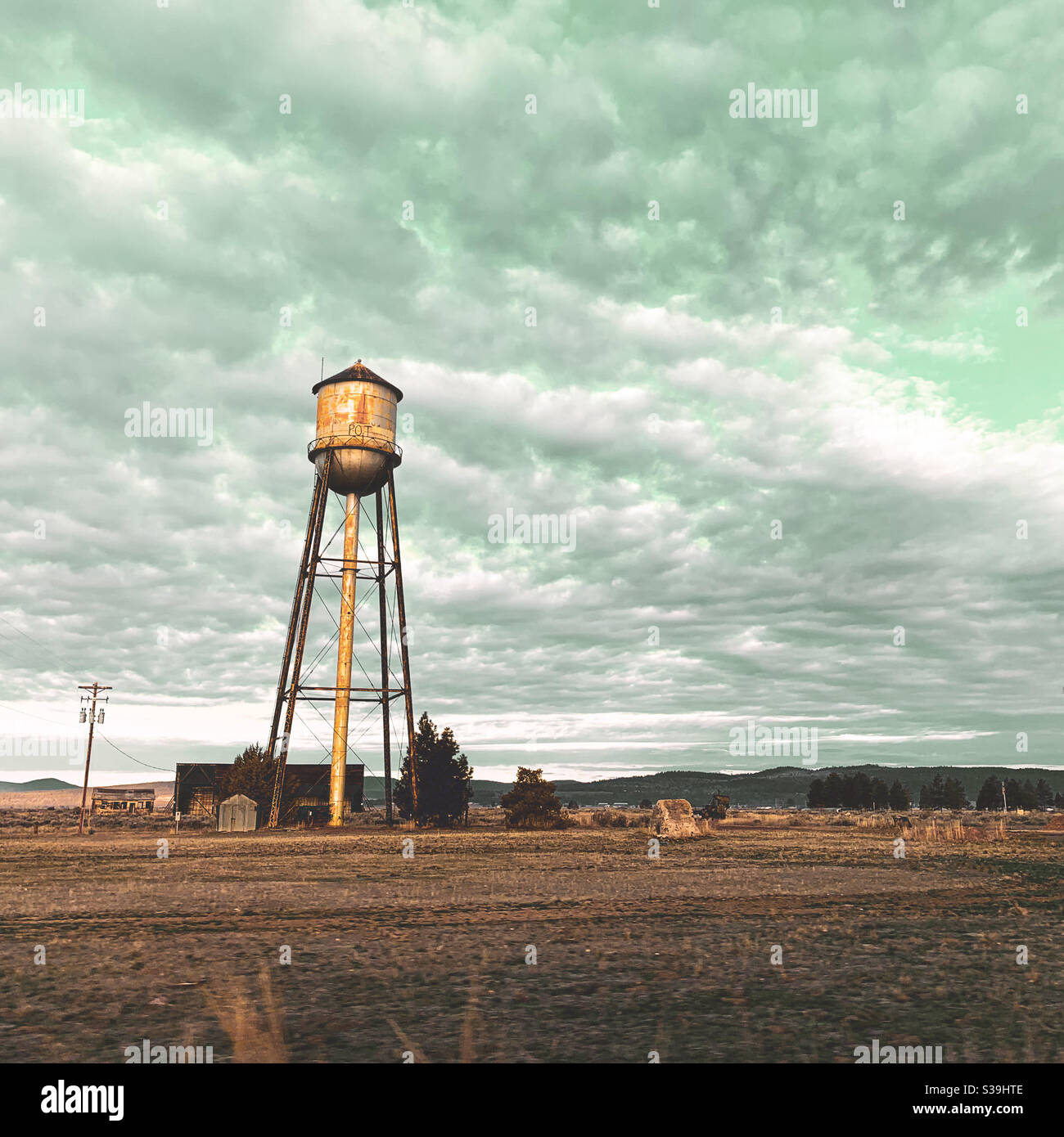 Water tower in the early morning light under a cloudy sky in California. Square crop. - Smartphone Captured Stock Image