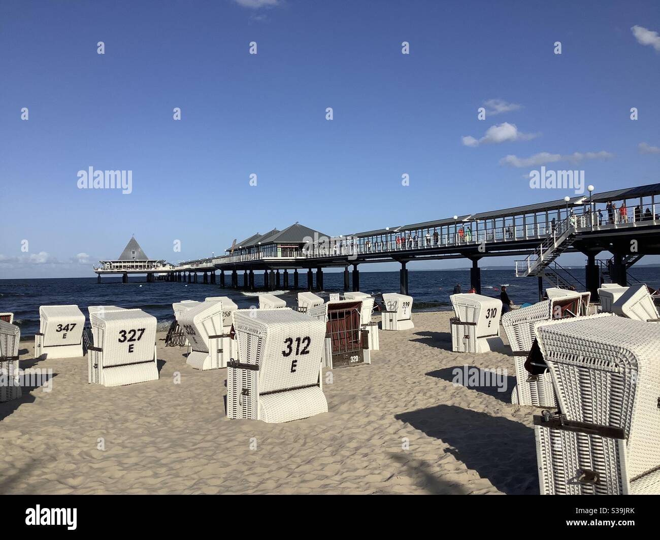 Wicker beach chairs on the sandy beach of Heringsdorf and the pier, Imperial Baths, Baltic Sea, Usedom, Mecklenburg Vorpommern, Germany, Europe Stock Photo