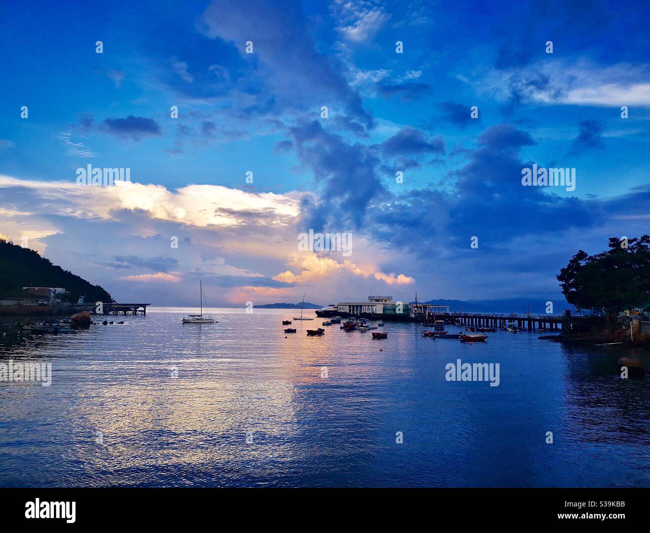 Dawn over the Yung Shue Wan pier on Lamma island in Hong k. - Smartphone Captured Stock Image