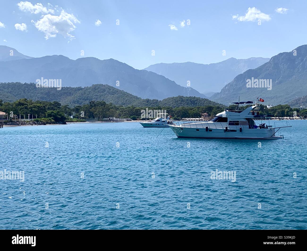 Boat in the bay of Kemer Antalya turkey with mountains in the background - Smartphone Captured Stock Image
