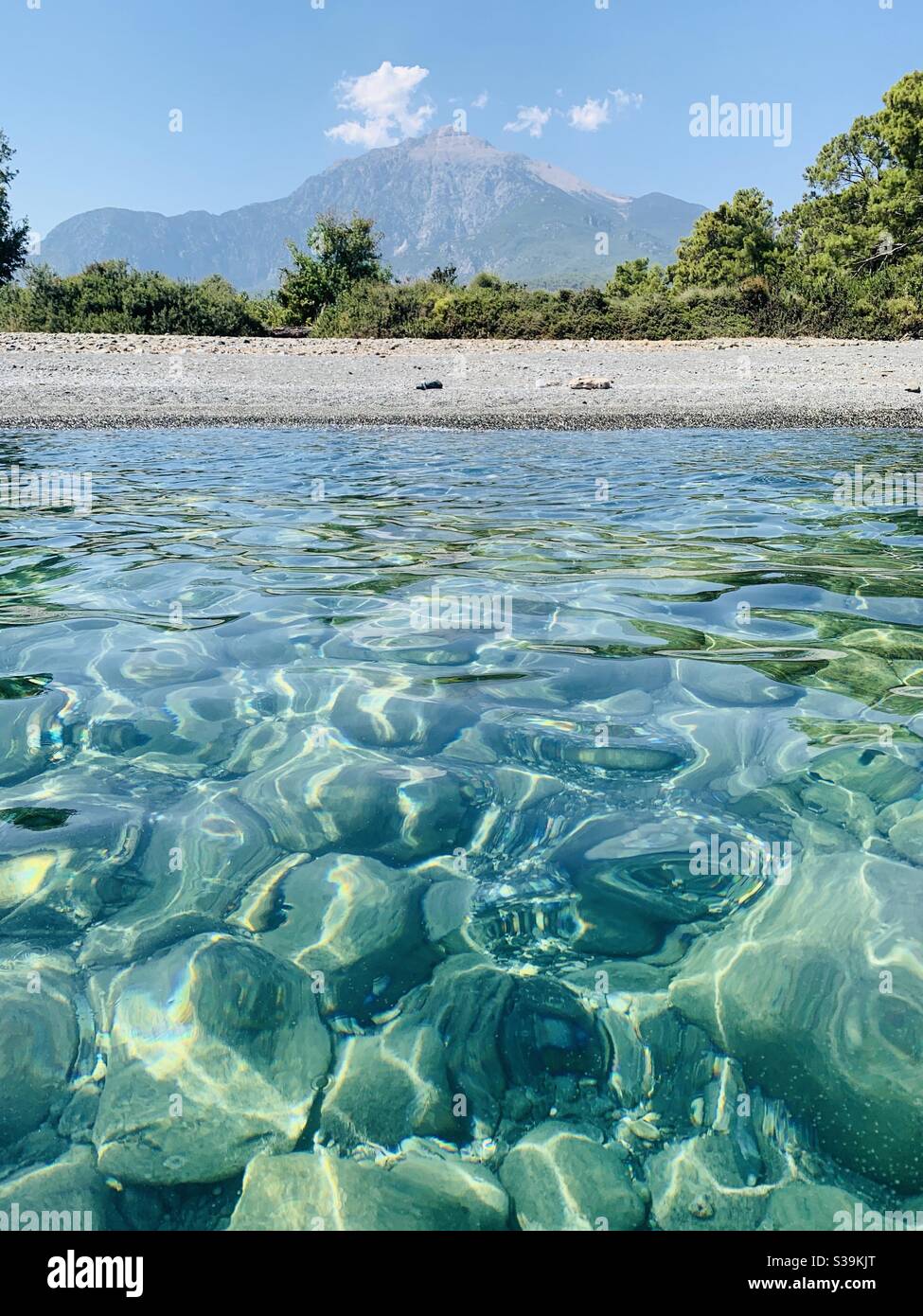 Portrait view of Tahtali mountain with crystal clear water and deserted beach - Smartphone Captured Stock Image