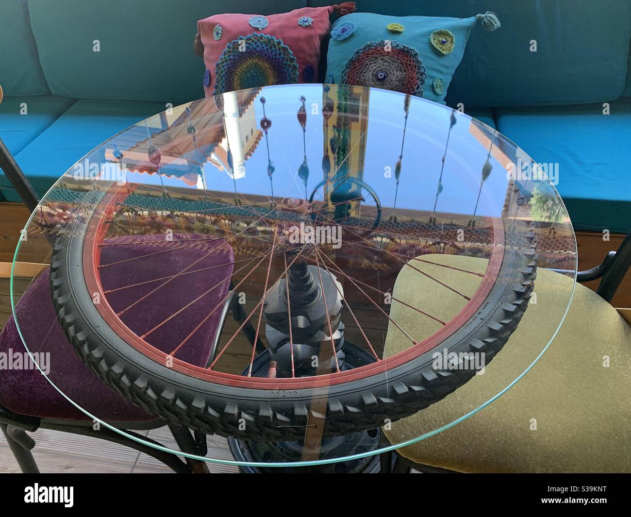 Glass table with wheel underneath and reflection - Smartphone Captured Stock Image