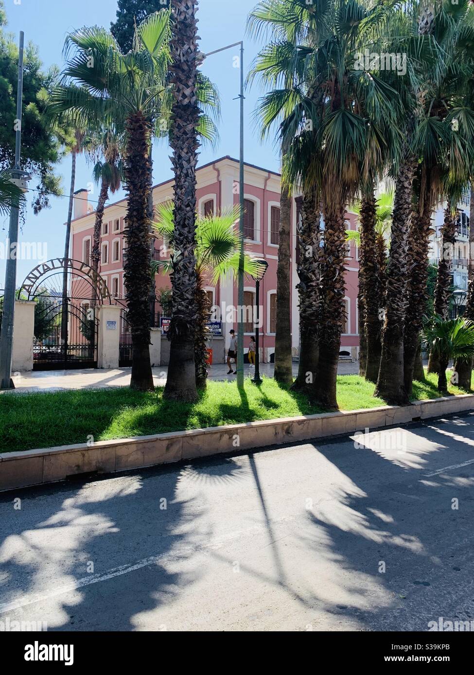 Street scene in Kaleiçi Antalya with a pink house and palm trees - Smartphone Captured Stock Image
