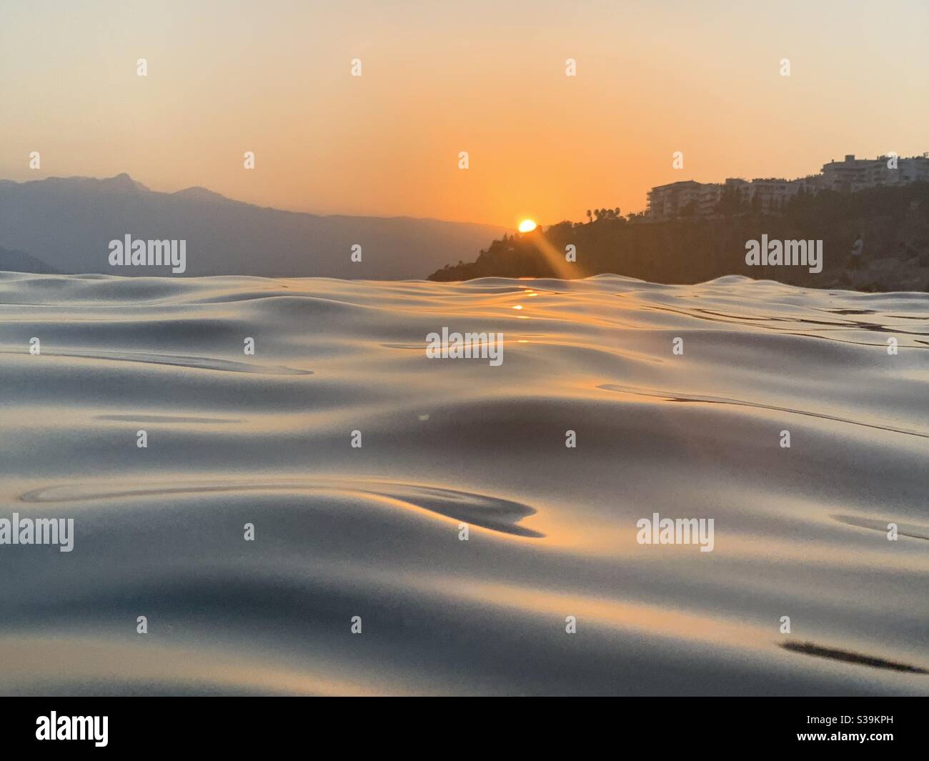 Sunset over the waves at Mermerli beach Antalya - Smartphone Captured Stock Image