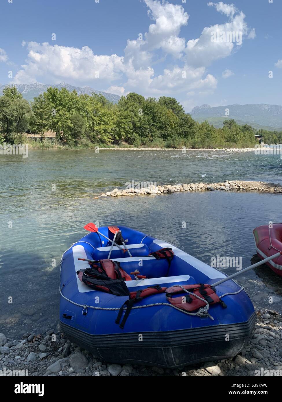Empty Blue rafting boat waiting by the river for passengers in river Manavgat - Smartphone Captured Stock Image