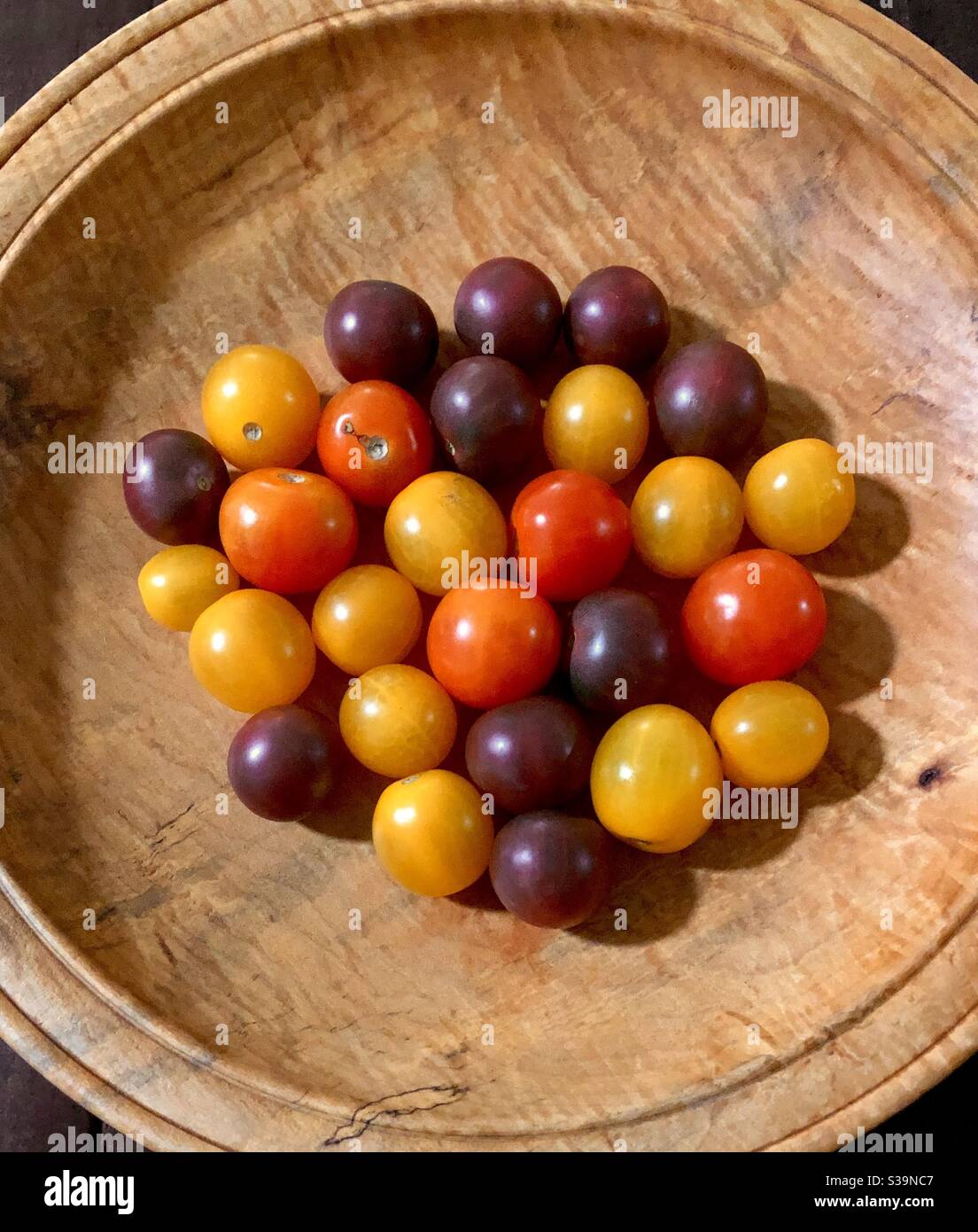 Overview of a bowl of colorful heirloom tomatoes. - Smartphone Captured Stock Image