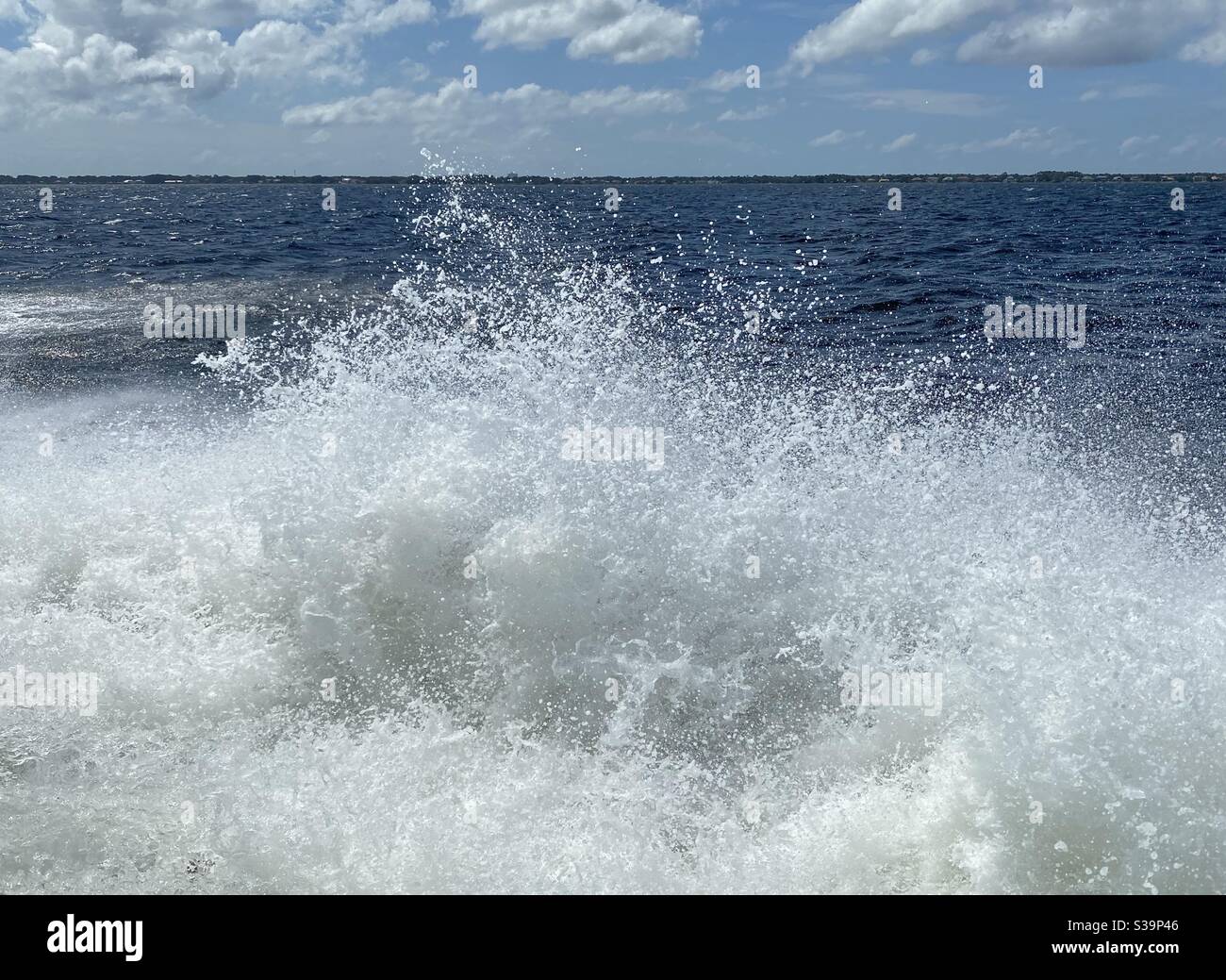 Large motion boat spray over blue Gulf of Mexico water Florida - Smartphone Captured Stock Image