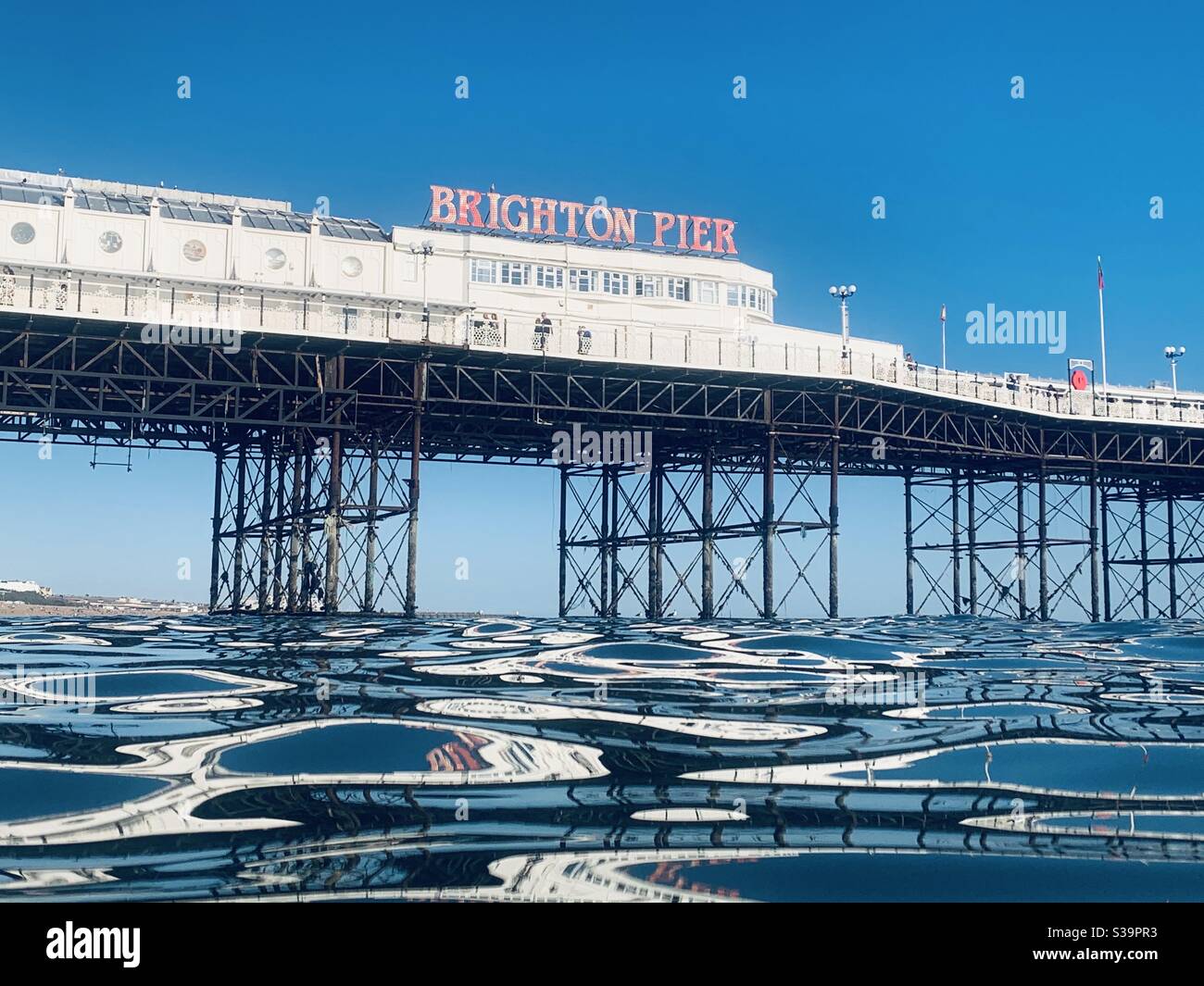 View of Brighton pier from the water with ripples - Smartphone Captured Stock Image View of Brighton pier from the water with ripples - Smartphone Captured Stock Image
